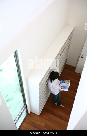 A young woman reading magazine Stock Photo