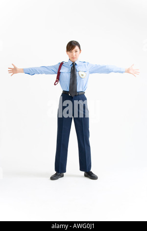 A female security guard standing with her arms outstretched Stock Photo