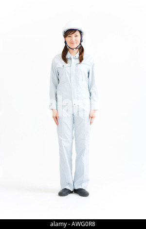 A female construction worker wearing a hardhat Stock Photo