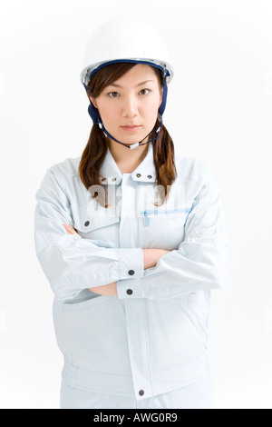 A female construction worker wearing a hardhat Stock Photo