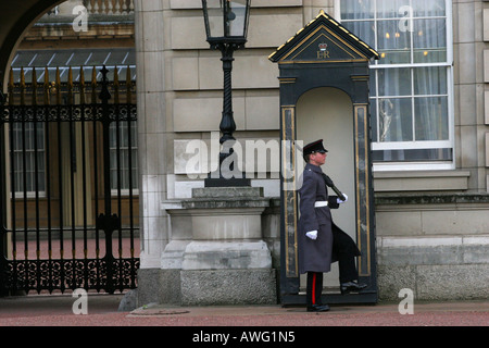 Iconic image of a marching Buckingham Palace guard on sentry duty infront of guard hut outside the royal palace London England Stock Photo