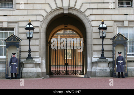 Iconic image of two Buckingham Palace guards on sentry duty infront of guard huts outside the royal palace London England UK Stock Photo