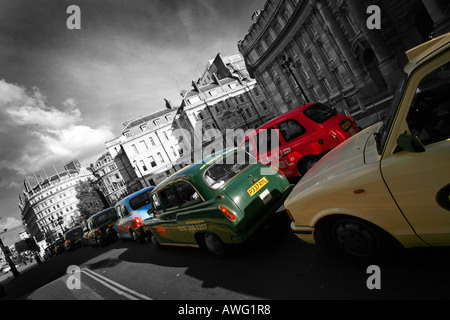 Multi coloured London taxi cabs cars stationary in congestion traffic jam central London England UK EU Stock Photo