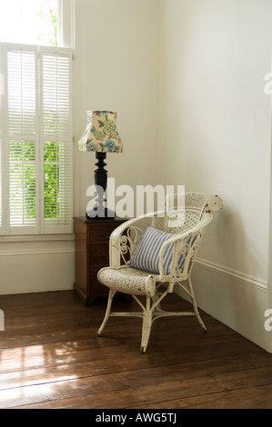 Armchair and lamp in bedroom corner in London home of a well known chef Stock Photo