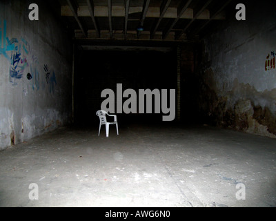 Chair in basement loneliness concept Stock Photo