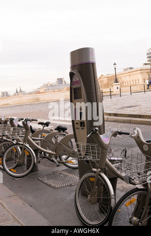 Velib cycle scheme in Paris on Quai de L'Horloge, Île de la Cité at Pont Neuf opposite the Palais de Louvre Stock Photo