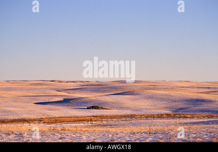Light dusting of snow on the short cropped wheat fields of late fall in southern Alberta Canada Stock Photo