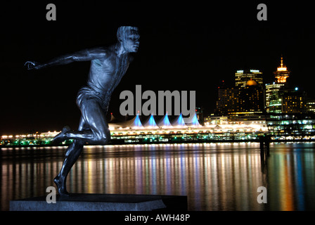 A statue of the famous track and field Olympic runner Harry Jerome , taken in Stanley park at night . Stock Photo