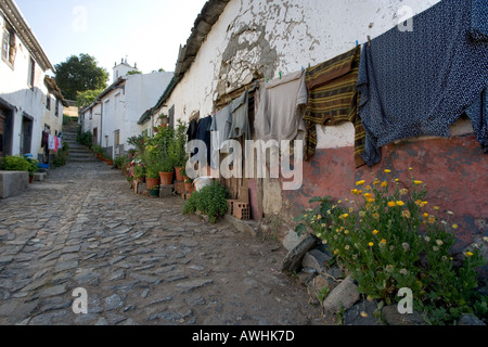 Laundry dries along a narrow roadway inside the walls of the 13th century citadel above the town of Braganca, Portugal. Stock Photo