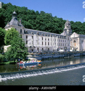 Brantome and the Benedictine Abbey beside the weir on the River Dronne with tourists in boat Stock Photo