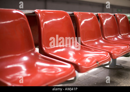 five red plastic seats in a row Stock Photo