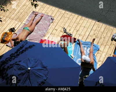 france ile de france paris paris plage young women sunbathing on sun deck Stock Photo