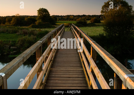 Wooden footbridge across the River Stour near Wimborne in Dorset. Known locally as Eyebridge (Eye Bridge). Stock Photo