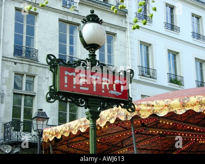 Art Nouveau Metro sign with light outside a Metro station in Paris Stock Photo