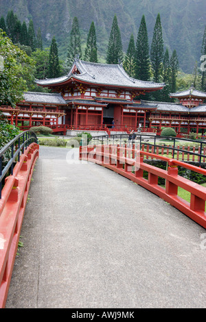 Approach to the Byodo-In Japanese Temple on Oahu Island,Hawaii,is over the elegant red painted bridge Stock Photo