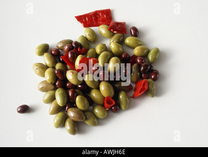 Pile of spicy green and black olives, white background Stock Photo