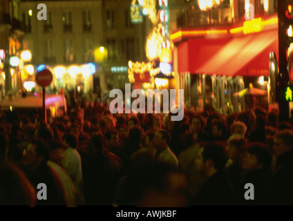 France, Paris, people in street at night, blurred Stock Photo
