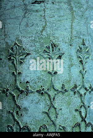 Floral motif sculpted on bluish surface Stock Photo