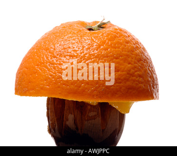 Half an orange on a wooden orange squeezer Stock Photo