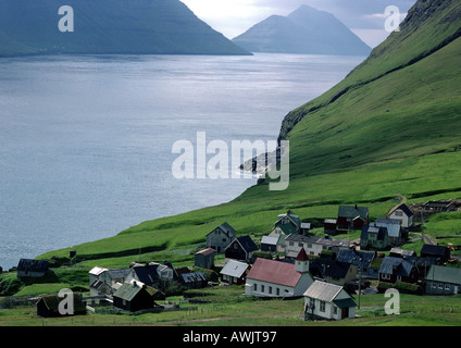 Scandinavia, village overlooking sea with mountains in background Stock Photo