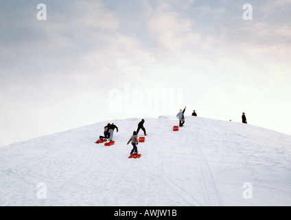 Sweden, sledders walking up hill Stock Photo