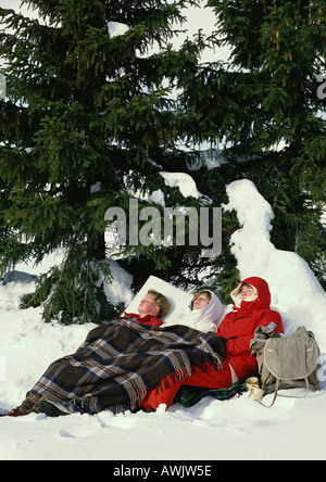 Sweden, hikers sleeping near fir tree Stock Photo