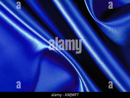 Folds in blue satin, close-up, full frame Stock Photo