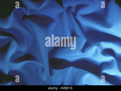 Folds in blue fabric, close-up, full frame Stock Photo