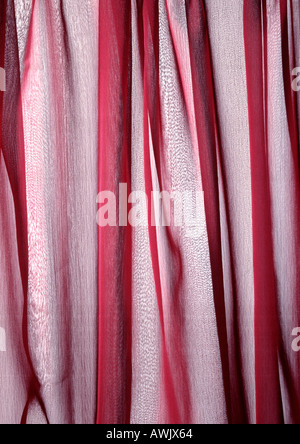 Folds in sheer red fabric, close-up, full frame Stock Photo