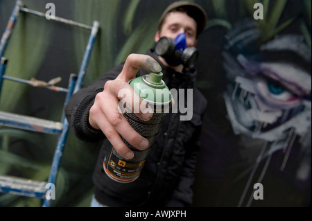 A graffiti artist sprays a wall Stock Photo - Alamy