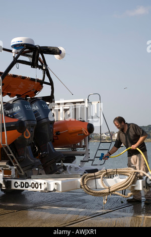 Washing down the Mudeford lifeboat after a job. Stock Photo