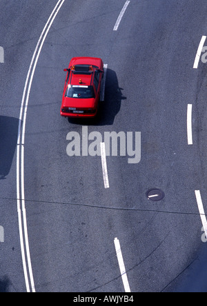 Red car on road with white lines, high angle view, full frame Stock Photo