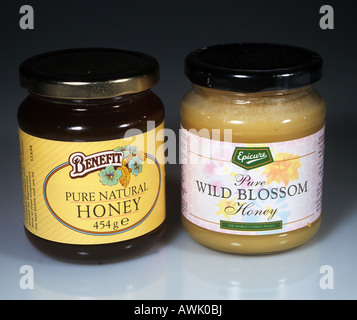 Jars of commercially available honey one clear and one opaque Stock Photo