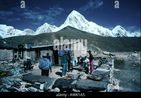 Tourist at lodge with mountains in background, Gorak Shep, Pumori, Kala Patthar, Himalayas, Nepal Stock Photo