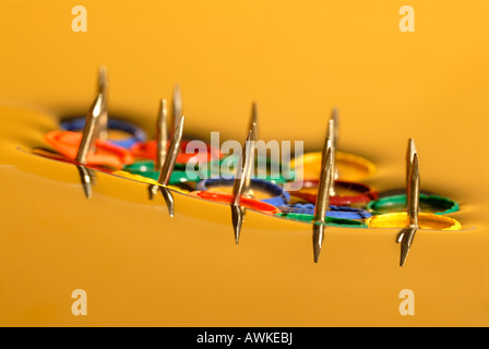 Drawing pins floating on water, surface tension Stock Photo