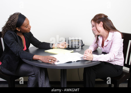 Stock Photograph of two people discussing the details of a sale Stock Photo
