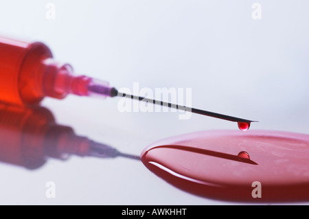 Medical syringe dripping blood nobody Stock Photo