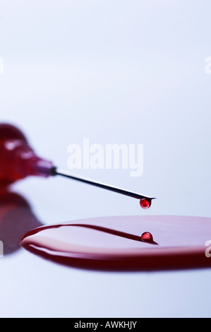 Injection syringe spilling blood Stock Photo