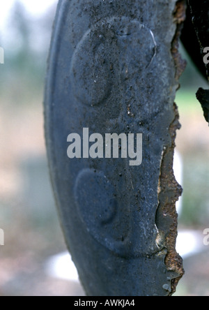 3 text embossed on broken metal surface Stock Photo