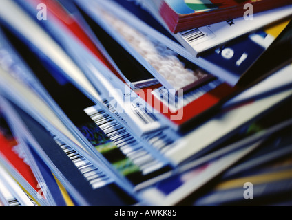 Disorderly stack of magazines, extreme close-up on corners with barcodes, full frame Stock Photo