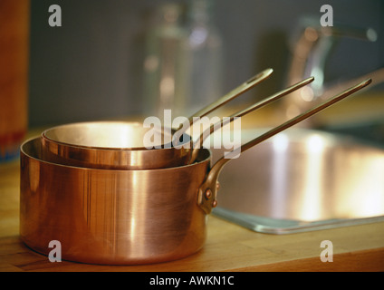 Copper pots on counter Stock Photo