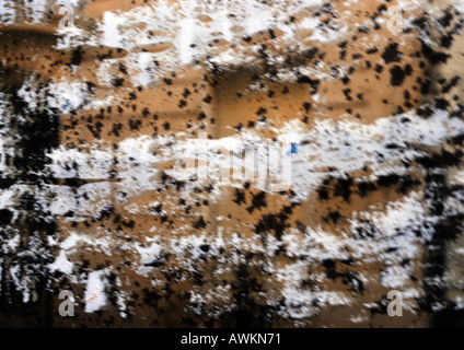 Black and white splatters on brown surface Stock Photo