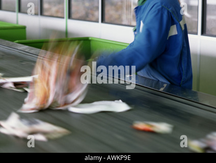 Trash being sorted on conveyor belt, cropped Stock Photo