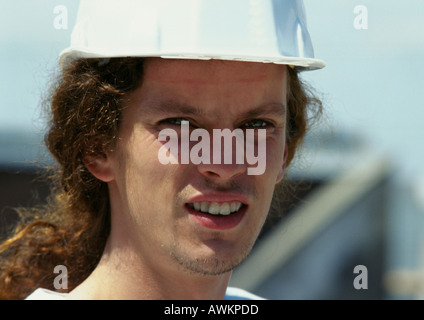 Man wearing hard hat, close-up Stock Photo