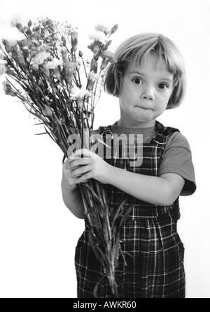 Little girl holding bouquet, b&w Stock Photo