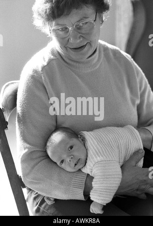 Mature woman holding baby, b&w Stock Photo
