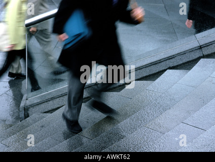 Man going up stairs, low section, blurred motion Stock Photo