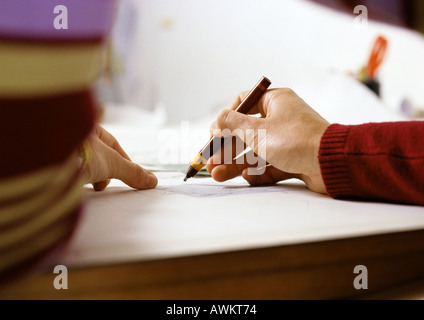Hand holding pen, close-up Stock Photo