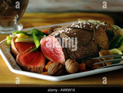 Roast beef with vegetables on dish, close-up Stock Photo