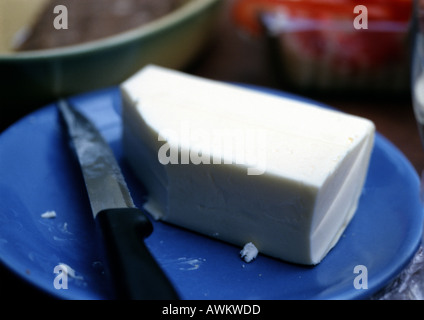 Butter on plate with knife Stock Photo